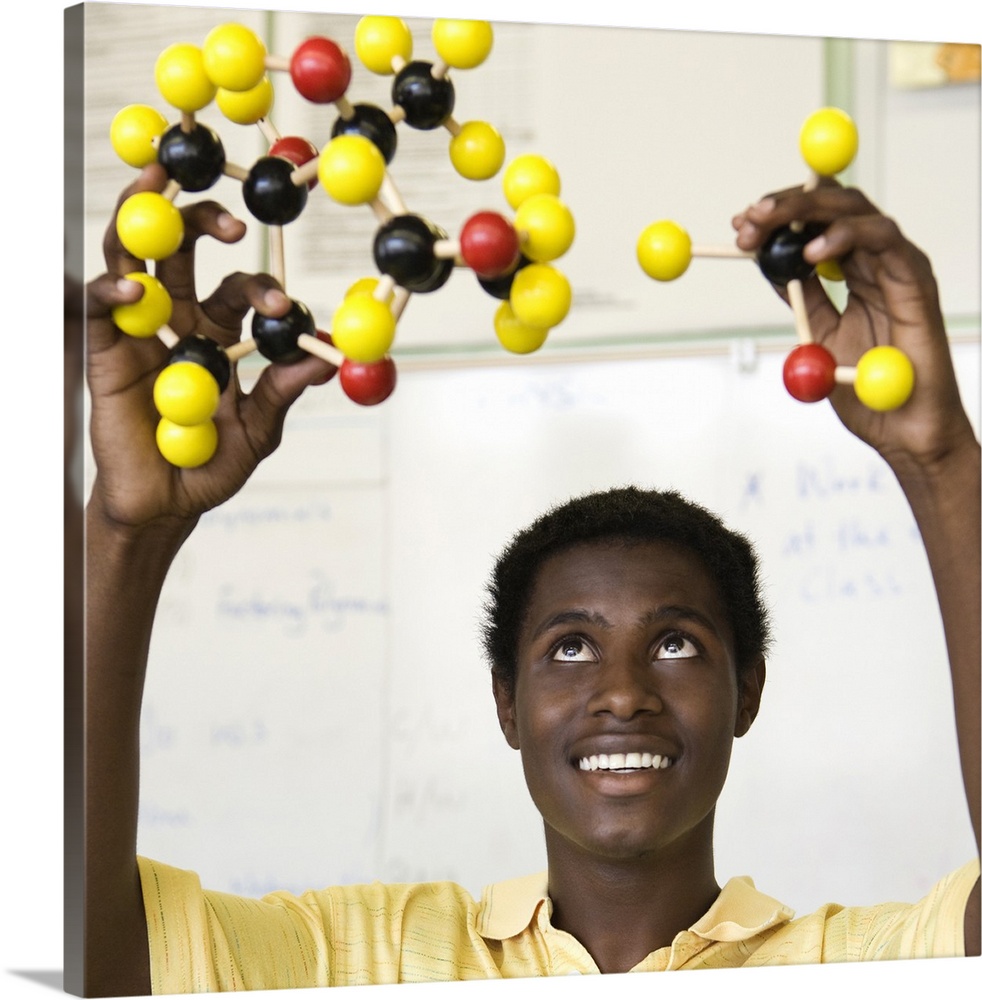 African teenage boy viewing molecule model