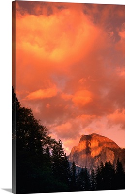 The clouds over the Half Dome are suffused with a brilliant orange glow