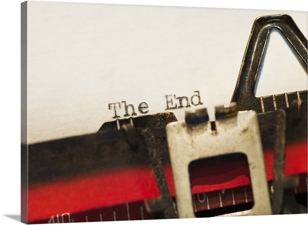This picture was taken closely zoomed in on a typewriter that had just written "The End" onto a blank piece of paper.