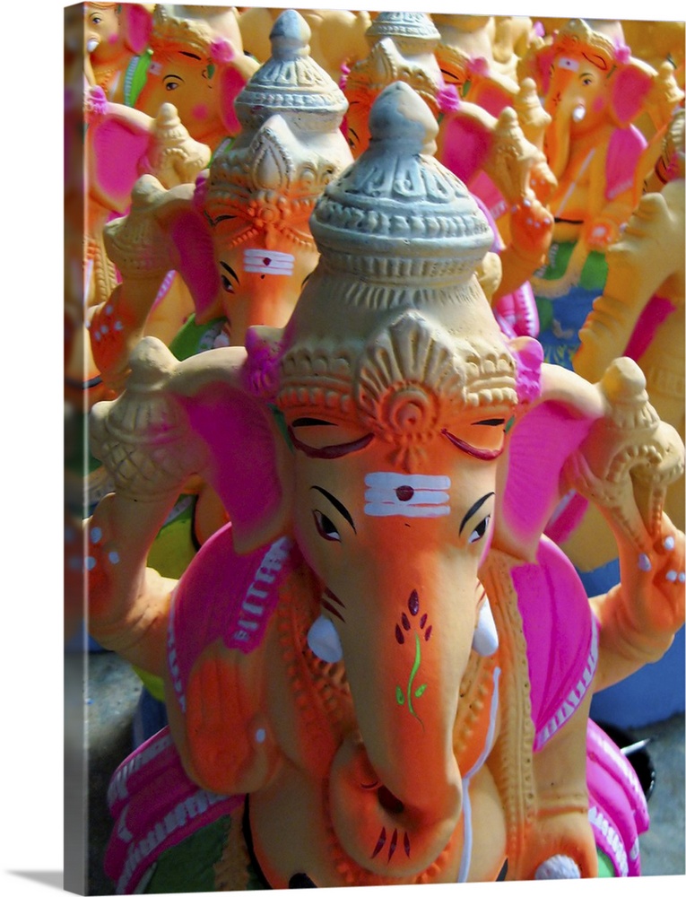 Hundreds of freshly painted statues/idols of Lord Ganesha (the Elephant God) are stacked. Made of clay, these idols are st...