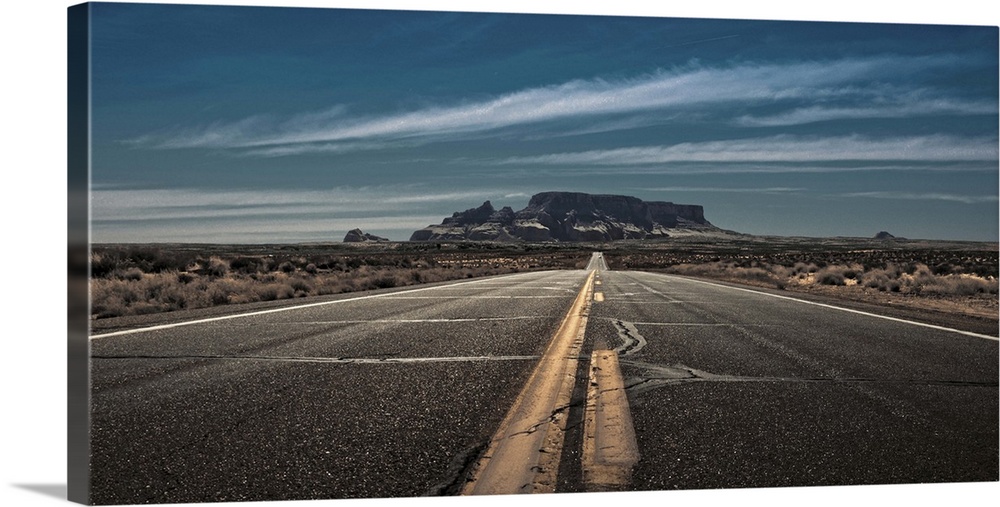 Highway on the way to Page, Arizona.  Red rock mountains in the distance. Desert road. American Southwest.