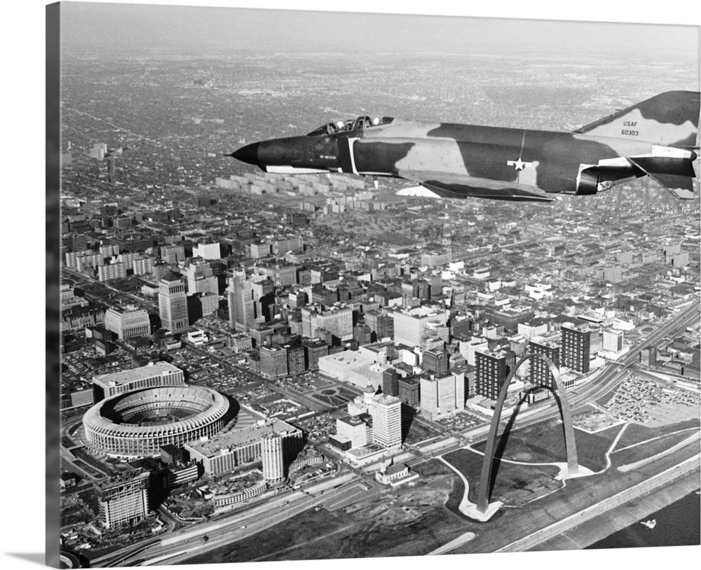 The Mcdonnell-Douglas F-4E Phantom, the fastest gun in the sky, draws a bead on the picturesque St. Louis waterfront - tak...