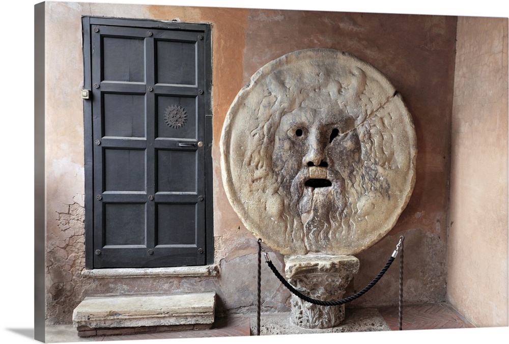 Horizontal photograph on a large canvas of the a metal door next to the roped off sculpture "The Mouth of Truth", in Rome,...