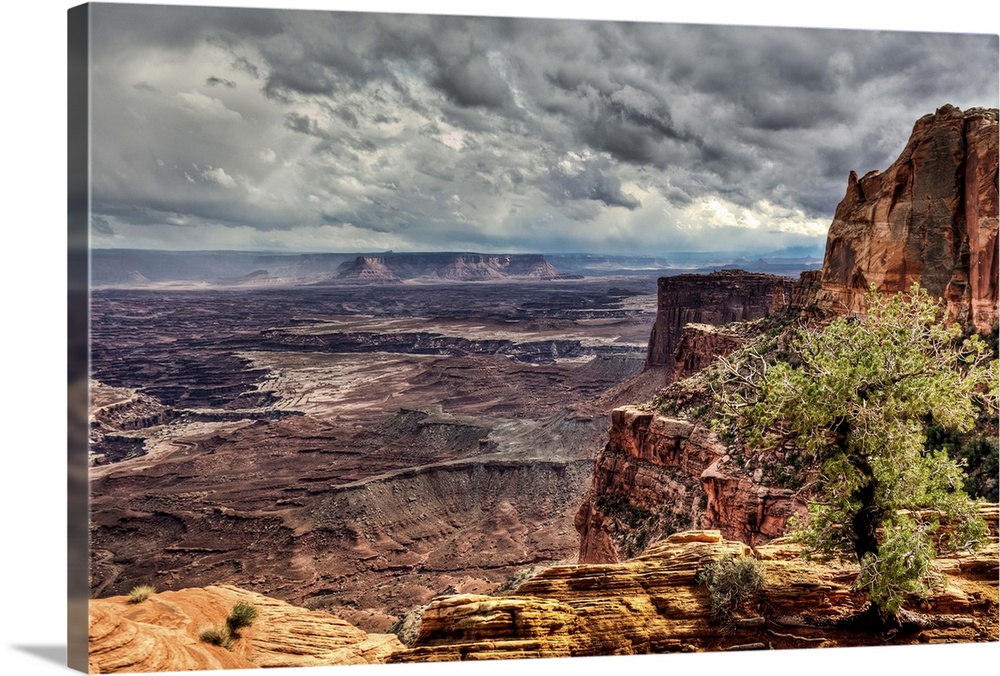 A view near Mesa Arch into the vast Canyonlands National Park during a stormy day.  A rare rain storm dropped 1/2 inch of ...