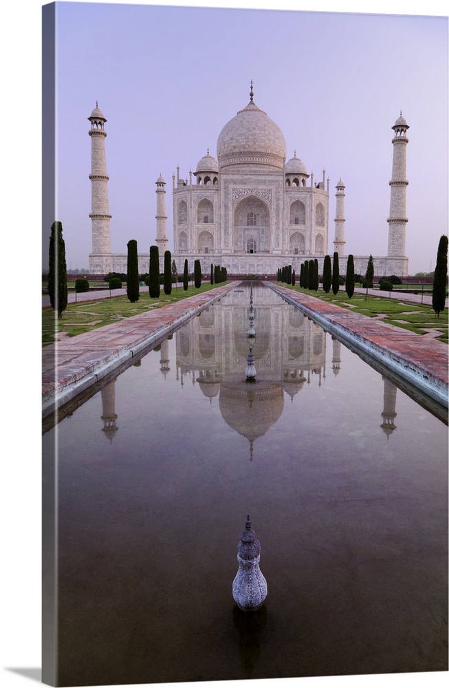 the Taj Mahal perfectly reflected in the pool in the Charhagh garden, early morning with no tourists