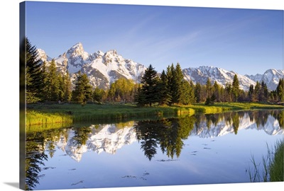 The Tetons reflect in Schwabacher's Landing in Grand Teton National Park, Wyoming
