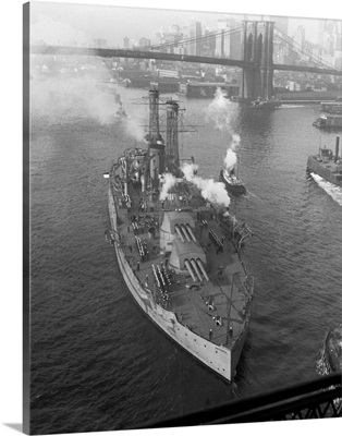 The U.S.S. Arizona passing out to sea under the Brooklyn Bridge