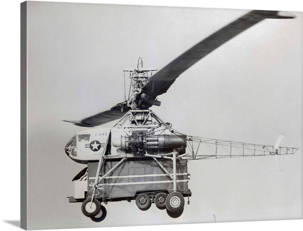 Like a giant dragonfly, the world's largest helicopter easily lifts a big Air Force van as it completes flight tests at Lo...