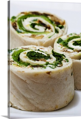 Tortilla rolls filled with goat's cheese and salad, close-up