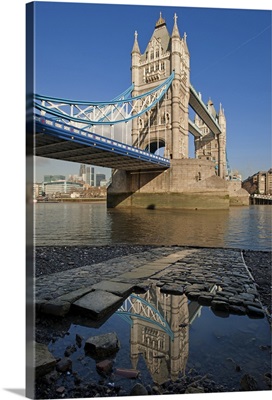 Tower Bridge, the River Thames and the Tower of London reflected in a pool, London.