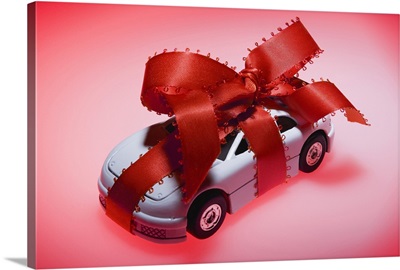 Toy car wrapped in ribbon