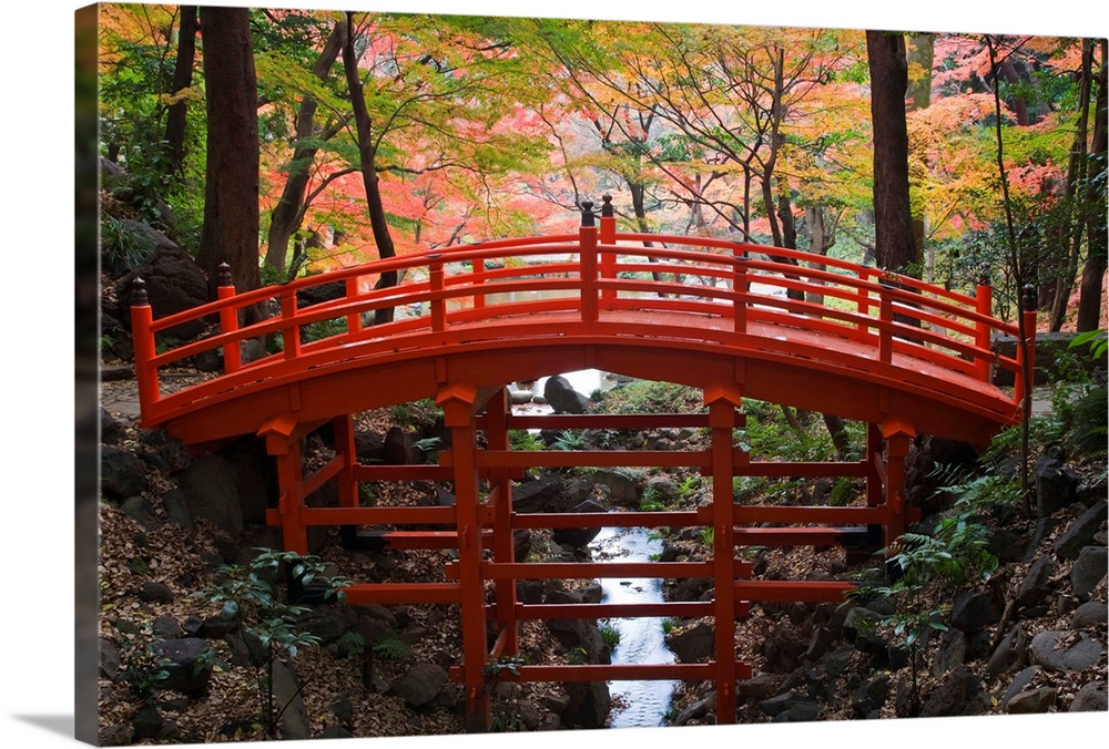 The vermilion-colored Tsutenkyo Bridge gracefully arches over a stream inside Koishikawa Korakuen Gardens, an Edo Period J...