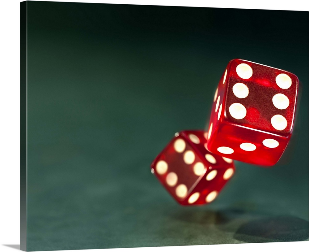 Two red casino dice tumble down onto a textured turquoise background