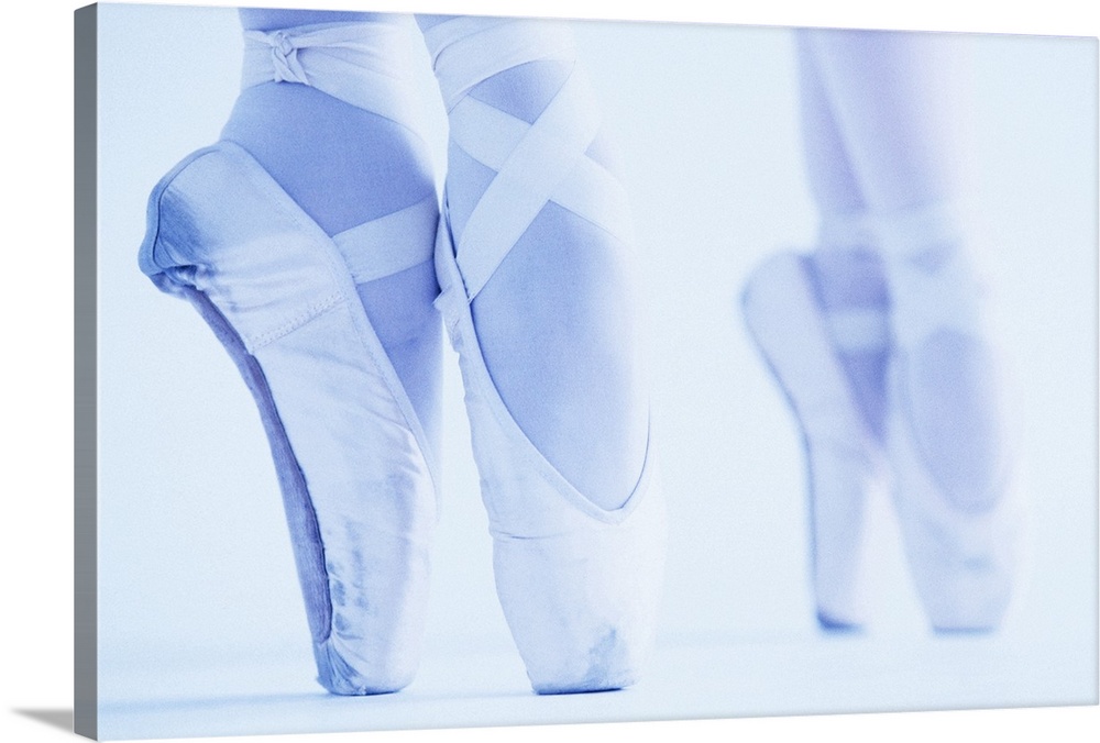 This low contrast wall art shows two pairs of feet dancing in against a light colored back drop.