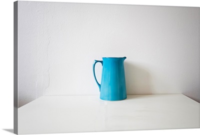 Turquoise jug on white kitchen table.