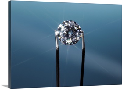 Tweezers holding diamond, close-up