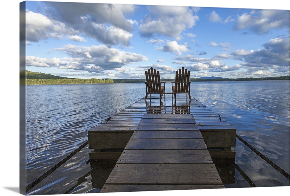 Two adirondack chair on a dock at Spencer Pond in northern Maine.
