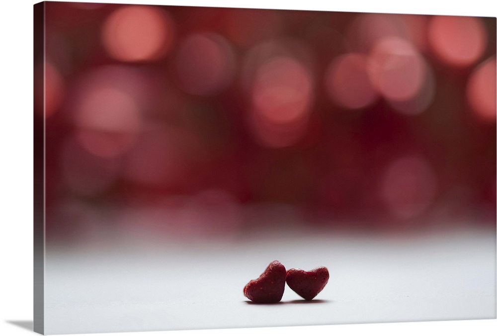 Two red hearts and red bokeh background