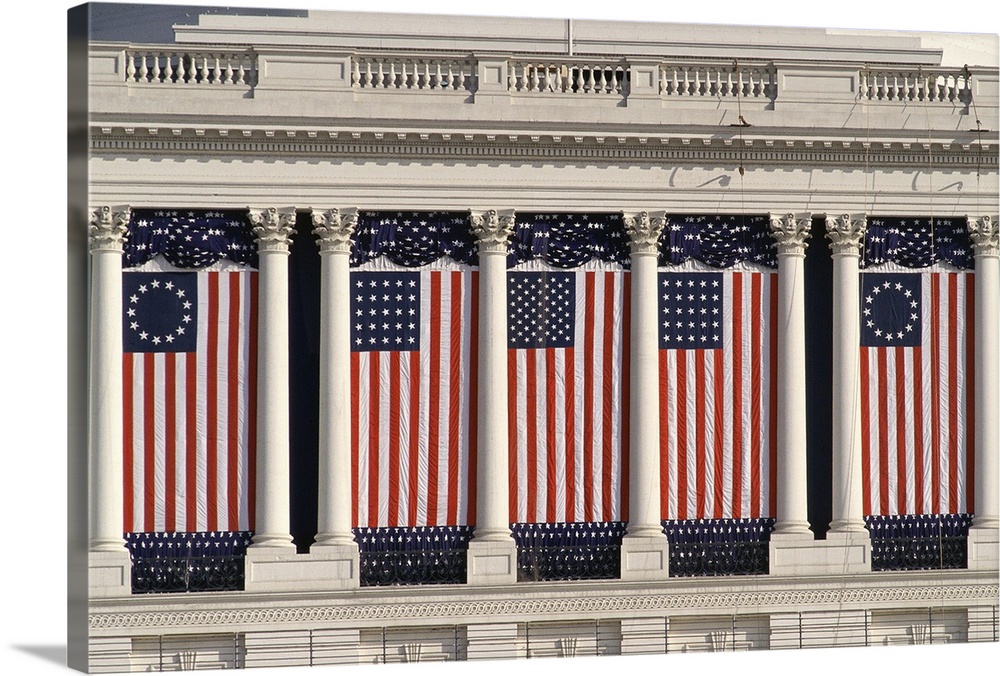 US Capitol Building with American flags draped between columns
