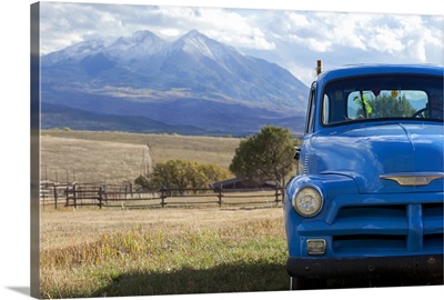 USA, Colorado, Carbondale, Blue vintage car, mount Sopris in background