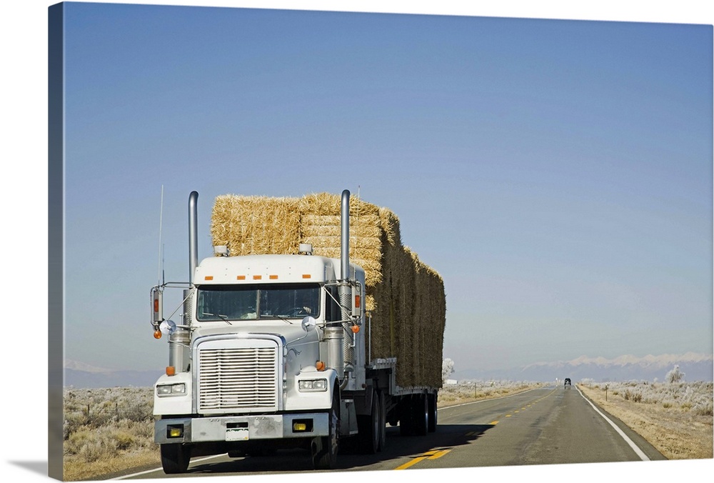 USA, Colorado, Truck hauling hay on rural road