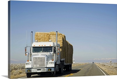 USA, Colorado, Truck hauling hay on rural road