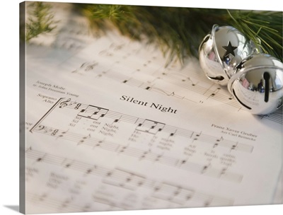 USA, New Jersey, Jersey City, Christmas baubles on carol music sheet