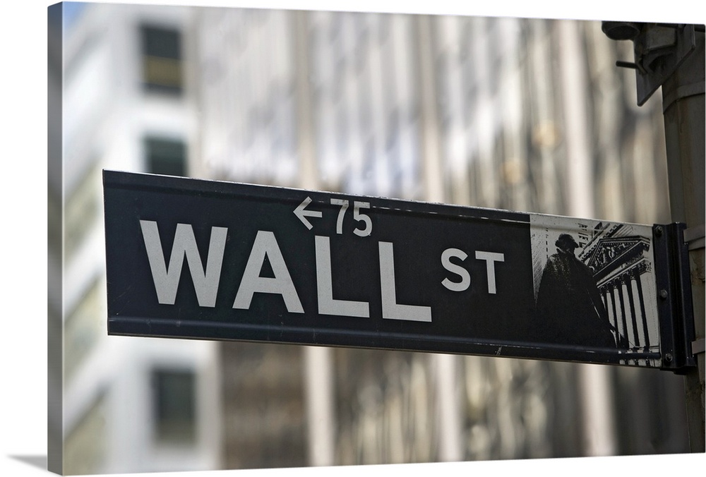 Large print of an iconic financial district sign with big city buildings in the background.
