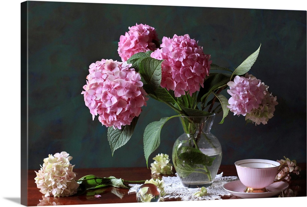Vase with Hortensia flowers on brown table with bowl, saucer, flowers.