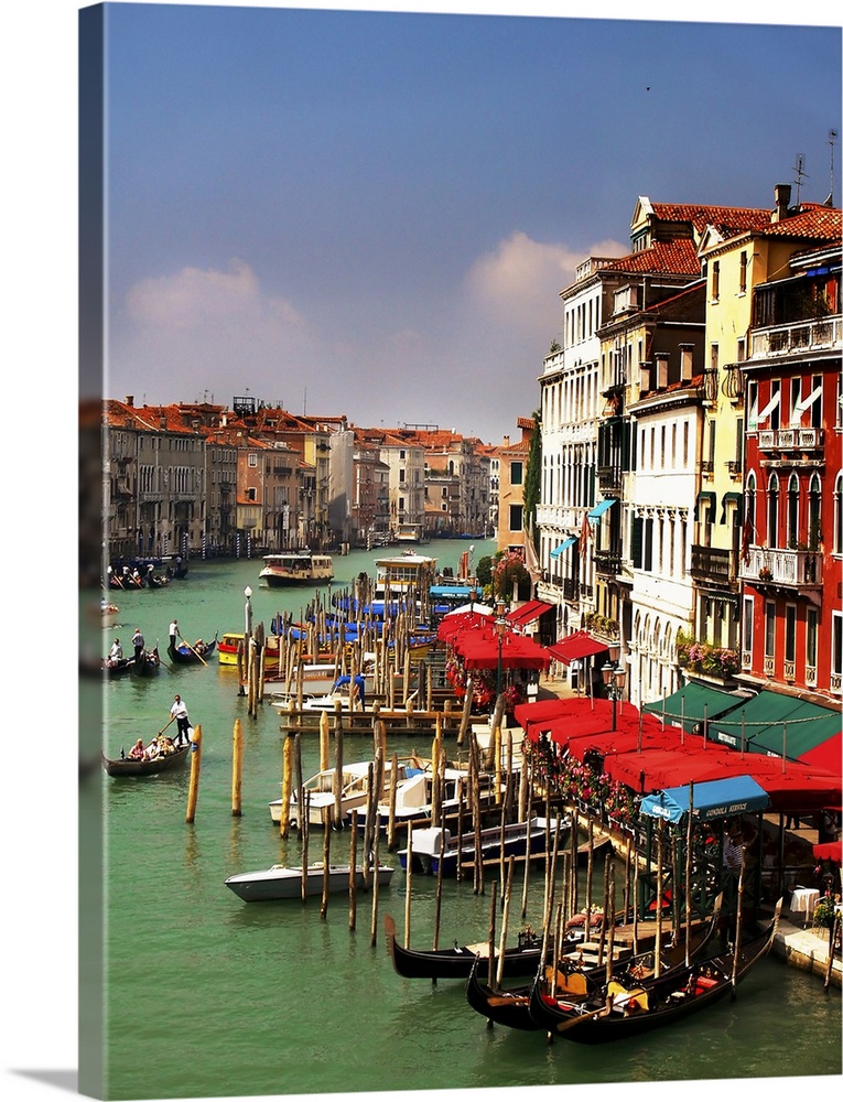 View of the Canale Grande and the gondolas from the top of the Rialto Bridge. Also you can see restaurant and hotels in th...