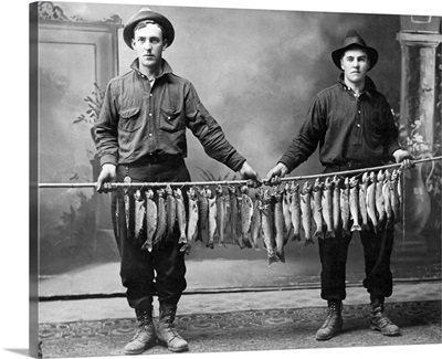 Vintage image of men holding string of fish
