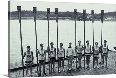 Vintage photo of a crew team holding up their oars