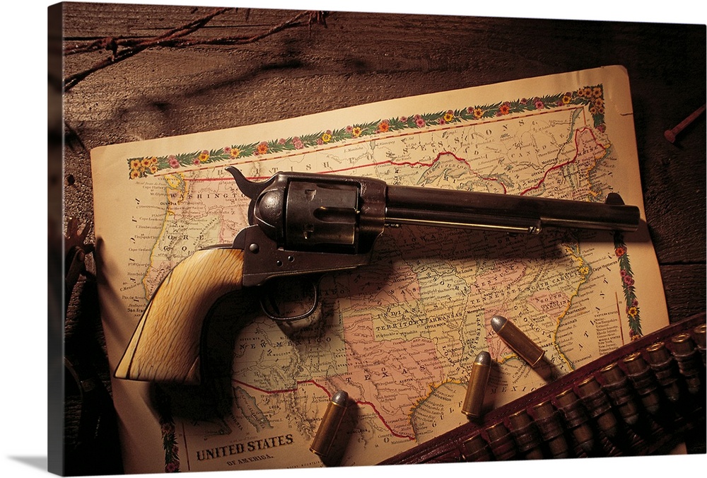 Vintage revolver with bullets and map