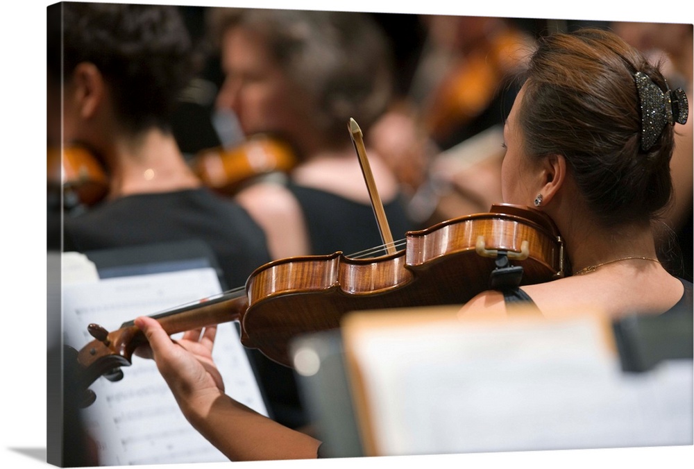 Viola players in symphony orchestra during performance (selective focus)