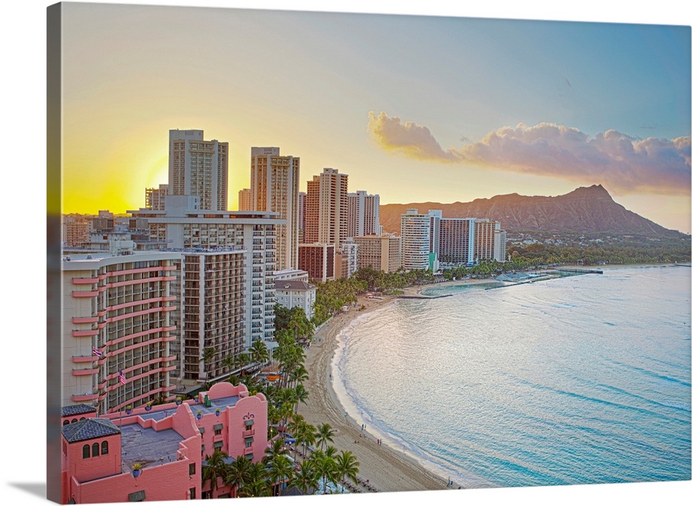 Landscape photograph on a large wall hanging of the sun rising over buildings along Waikiki Beach, Diamond Head Crater in ...