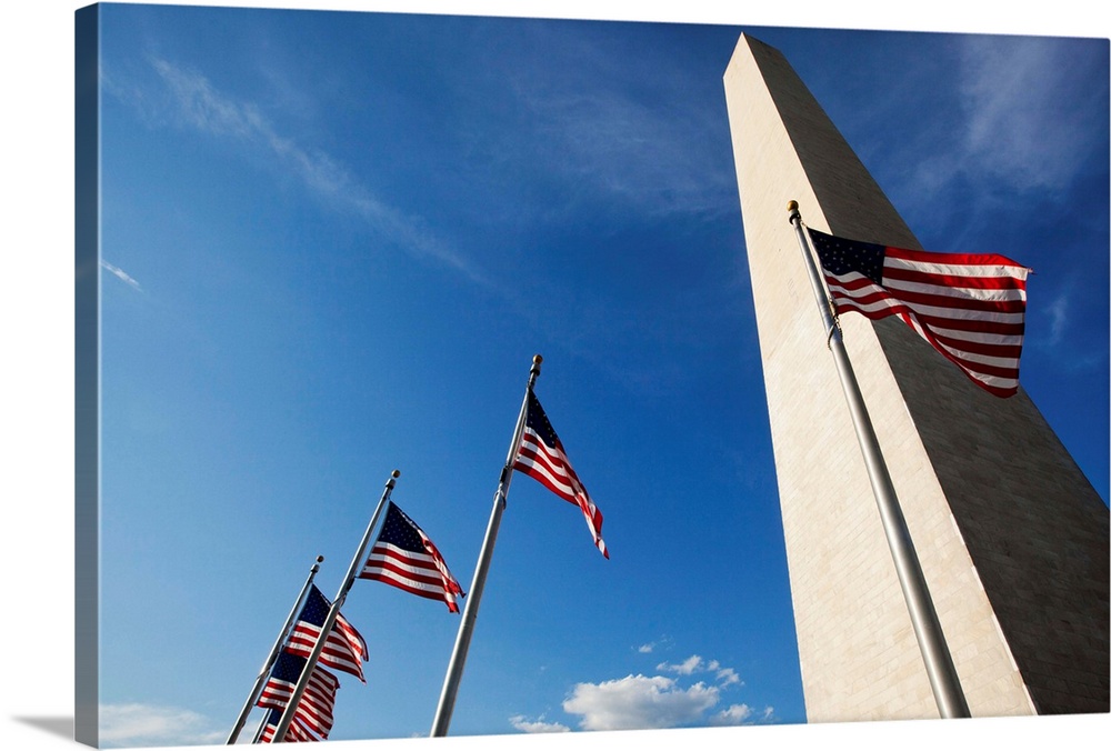 USA, District of Columbia, Washington, DC, Low angle view of American flags at base of Washington Monument at sunset on su...