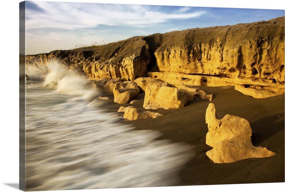 Waves splashing on limestone rocks.
