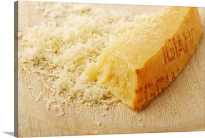 Wedge of partly-grated Parmesan cheese