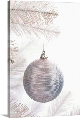 White bauble decoration on Christmas tree, close up