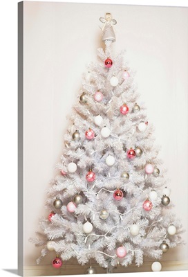 White Christmas tree with baubles and angel on top