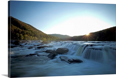 Wide waterfall seen in evening light with blurry water