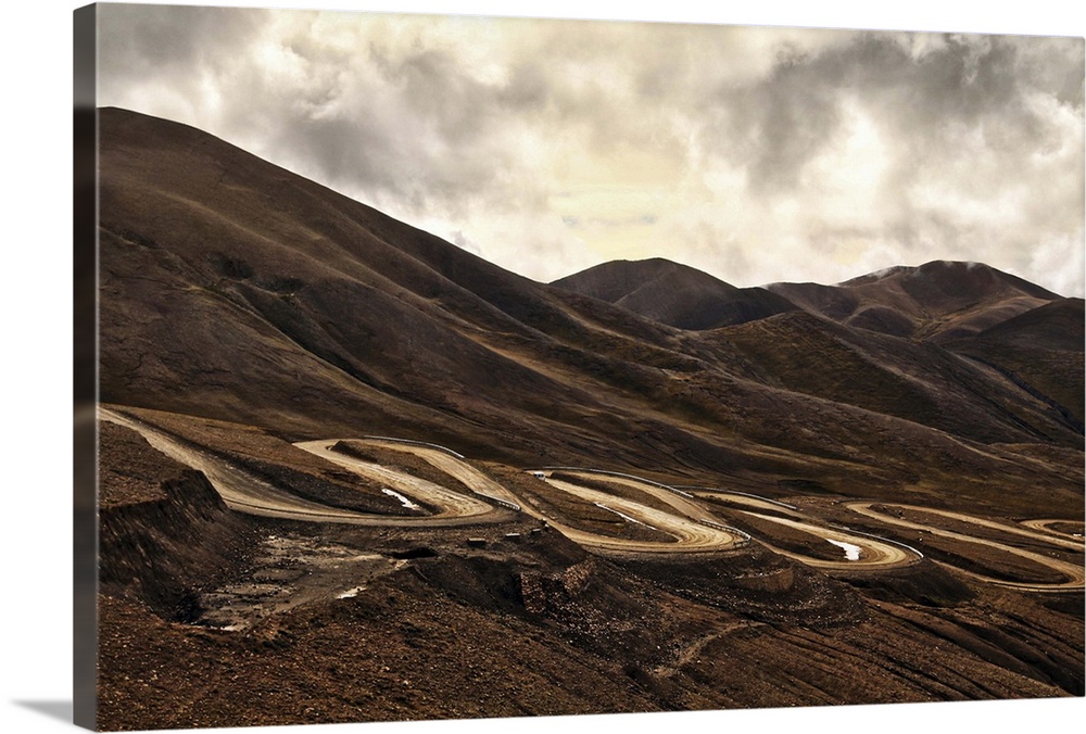 Route to Mount Everest along winding roads of Friendship Highway in Tibet, China on cloudy day.