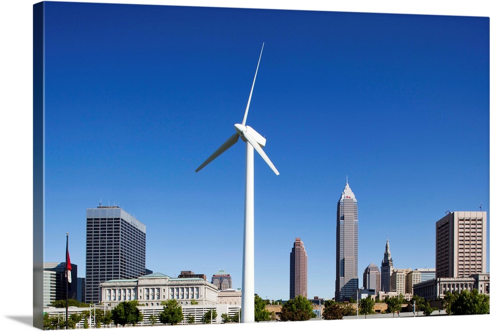USA, Ohio, Cleveland, Wind power generating turbine in park outside Omnimax Science Center along Lake Erie on cloudless sp...