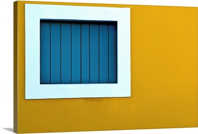 Window on yellow wall.