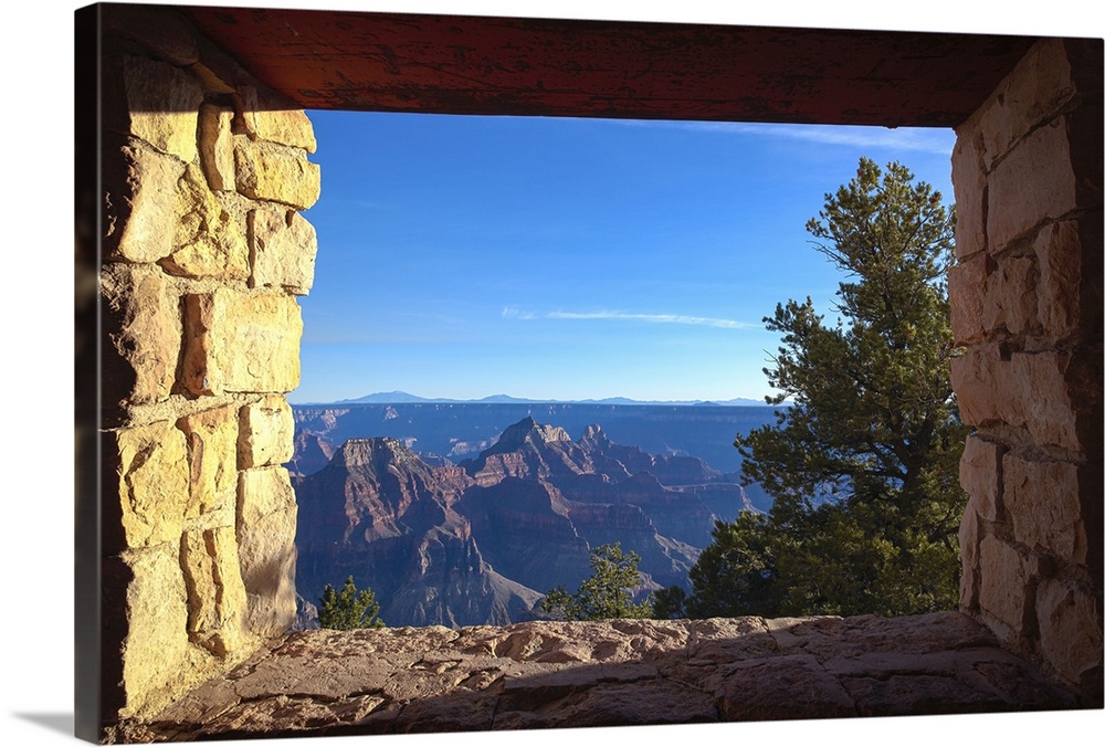 A stone window ledge showing a view of the North Rim of the Grand Canyon.