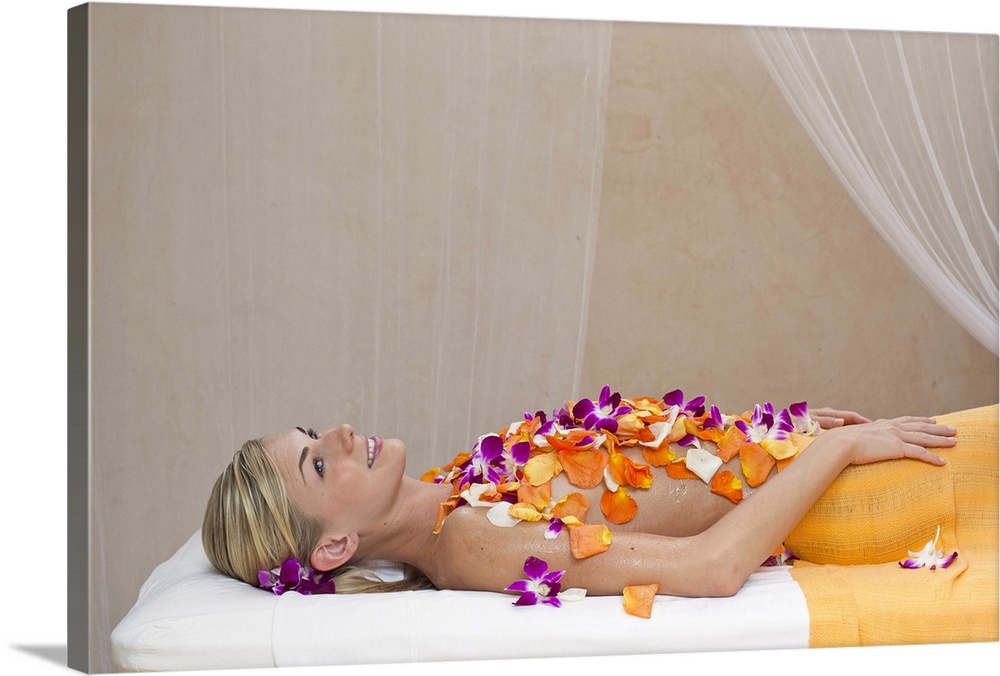 Woman getting a flower treatment at a spa.