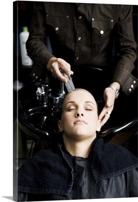 Woman getting her hair washed at salon