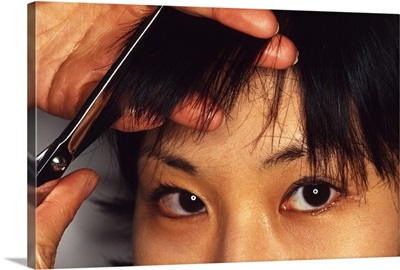 Woman having bangs cut