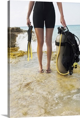 Woman holding scuba diving equipment