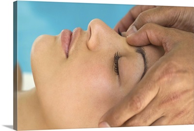 Woman receiving facial massage
